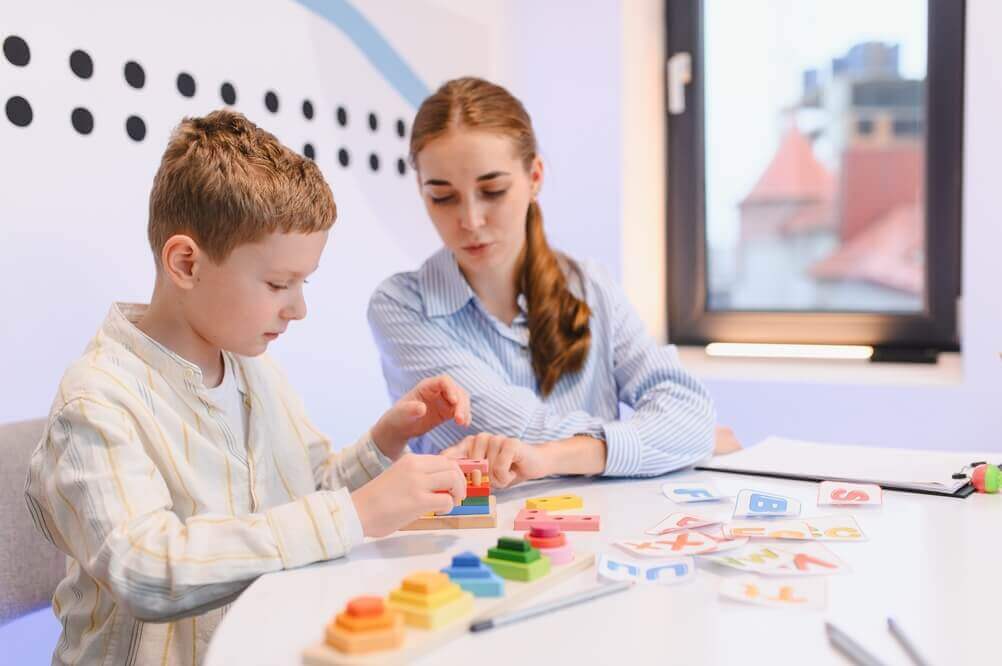 shutterstock_2730670583 insegnante di sostegno al lavoro con alunno per rappresentare master II livello docente di sostegno